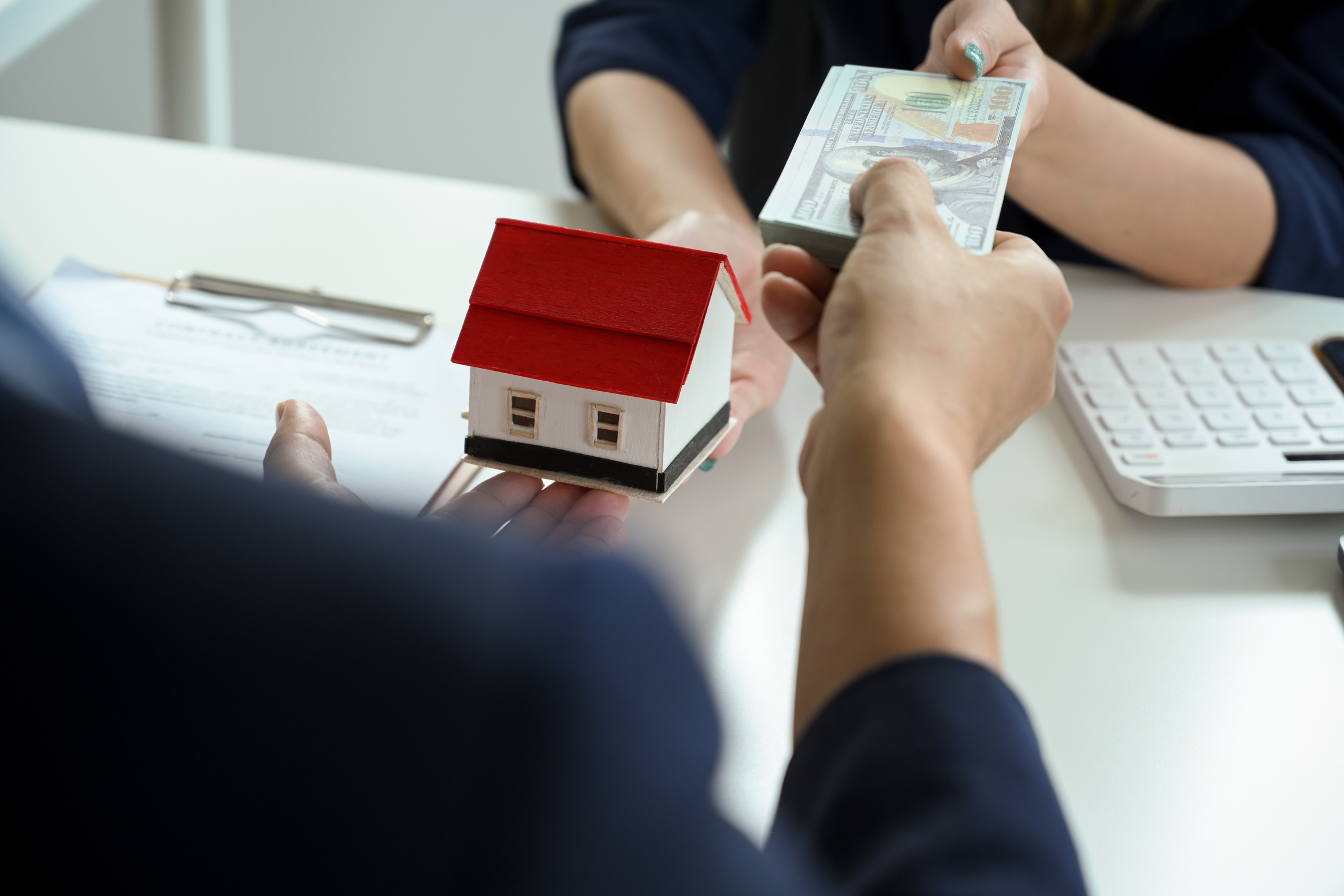 A male buyer pays his down payment for his property to a female